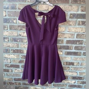 Pretty purple tied back dress.